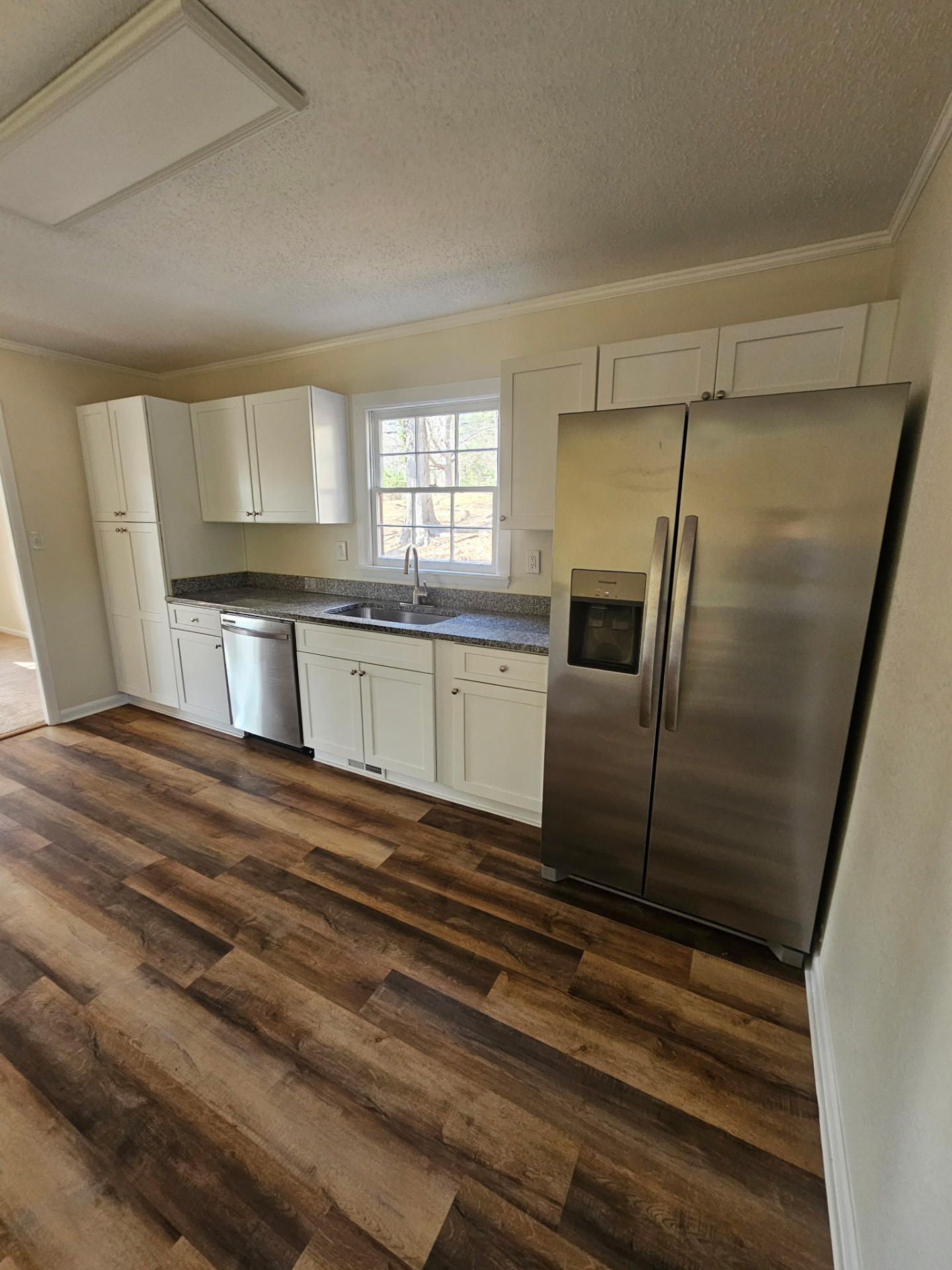 Recently remodeled kitchen with white cabinets and quartz countertops
