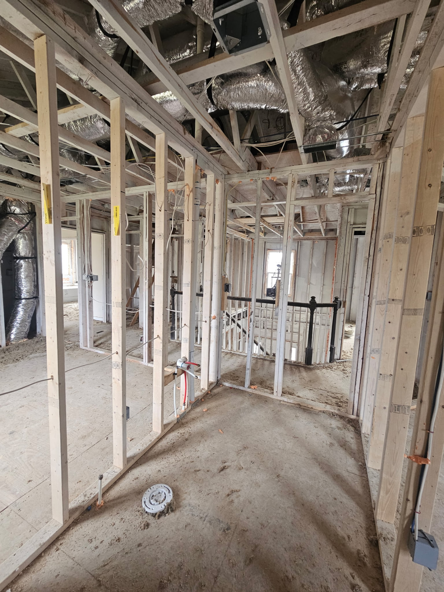 Interior tear-out complete with exposed framing and ductwork ready for rebuild
